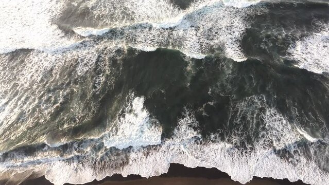 Top down view of black sand beach at El paredon Guatemala during sunrise