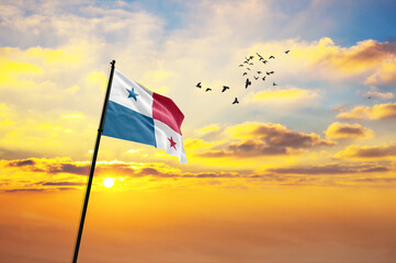 Waving flag of Panama against the background of a sunset or sunrise. Panama flag for Independence Day. The symbol of the state on wavy fabric.