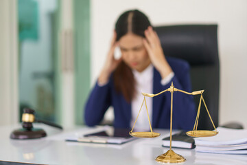 Lawyer woman headache and exhausted after have a problem with business contract and legal agreement