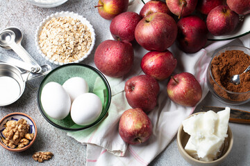 Baking ingredients: red apples, eggs, brown sugar, oatmeal, coconut oil, walnuts, salt, rice flour and spices. Home cooking concept
