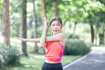 Sport woman warming up outdoors, Fitness woman doing stretch exercise stretching her arms