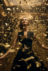 Portrait of a woman dancing on the stage. Confetti falls around her.