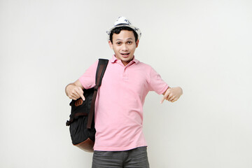Asian man backpacker portrait with ponting finger gesture. digital nomad and travelling concept. on isolated background