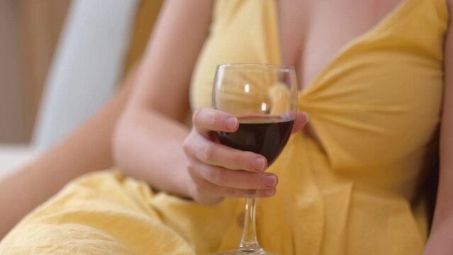 Sexy Woman Holding A Wine Glass With Red Wine. - clow up shot