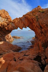 Fototapeta na wymiar Arco di Cala Romantica, a stone arch in Porto Cervo, Costa Smeralda, Sardinia, Italy