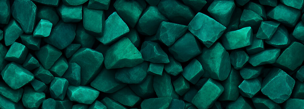 many jagged, rough-cut stones in various shades of deep teal and green, closely packed together to form a textured surface