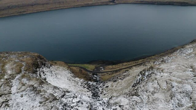 Faroe Islands, 4K Aeria wide and tilt down to reveal beautiful Foss&aacute; waterfall