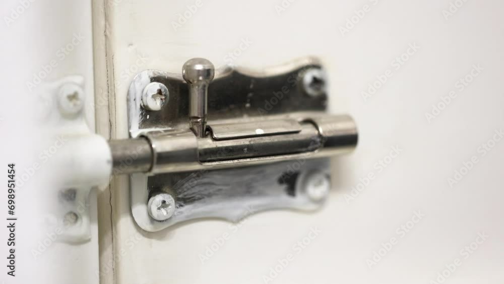Poster locking a door correctly with a simple latch on a closer view.