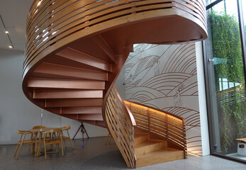 Beautiful Wooden spiral staircase inside the building   