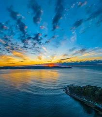 Fotobehang Aerial sunrise seascape with pretty cloud filled sky © Merrillie