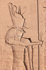 God Horus engraved on a pylon of the temple of Edfu - The Temple of Horus at Edfu, A large Ancient Egyptian temple - obrazy, fototapety, plakaty