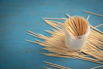 Wooden toothpicks on the blue background.
