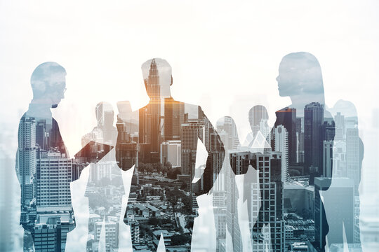 Creative city skyline with businesspeople silhouettes on light background. Teamwork, partnership and success concept. Toned image. Double exposure.