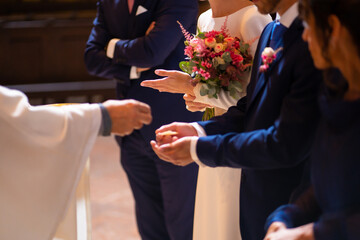 priest at a wedding at the ceremony gives bread to the bride and groom at the wedding
