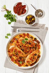 chicken breasts with vegetables, olives, top view