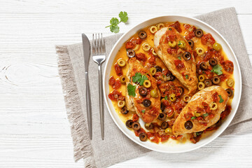 chicken breasts with vegetables, olives, top view