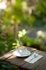 Hot art Latte Coffee. Background Coffee cup and beans on old kitchen table. 