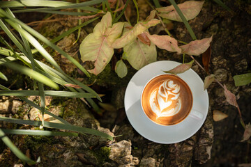 Hot art Latte Coffee. Background Coffee cup and beans on old kitchen table. 