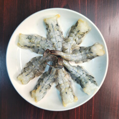 Fried Shrimp in white plate on wooden table, top view