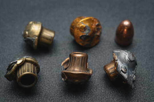 Crumpled bullets from a 9mm pistol, close-up photo.