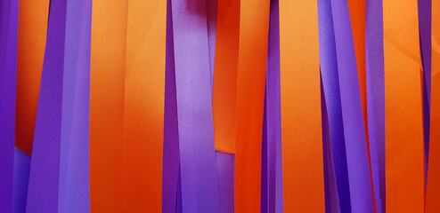 Purple or violet and orange ribbon background or wall. Pastel and colorful paper or fabric...