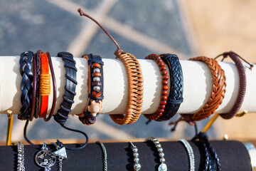 Handmade bracelets made of black and brown leather , for sale , close up 