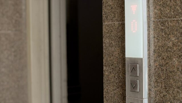 Indian woman walks inside empty elevator - apartment complex  lift control panel at mall  business centre  hotel. Girl entering lift - high-rise housing facility  pressing lift button  close-up of ...
