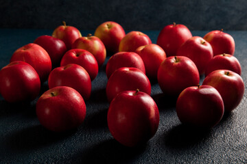 Lots of red ripe red apples on a blue background