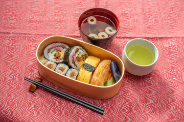 Fototapeta na wymiar すしべんとう　bento box with sushi rolls