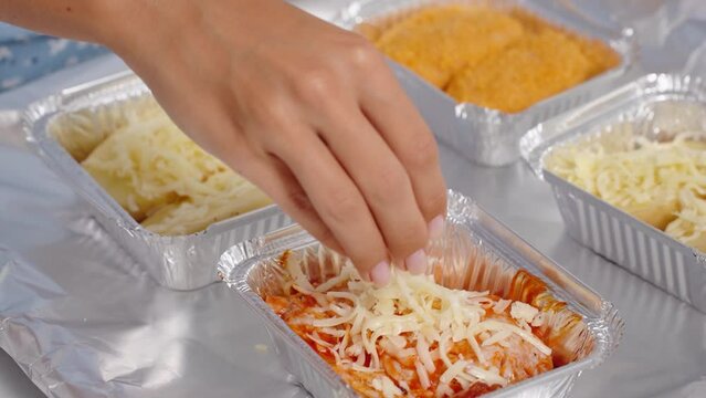 Laying food foil trays with food for baking