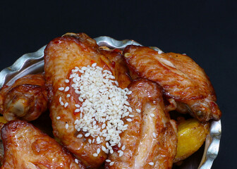 Grilled chicken wings with spices and sesame