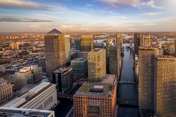 Panoramic view of the skyscrapers at the financial district Canary Wharf of London, England, during sunset time - obrazy, fototapety, plakaty