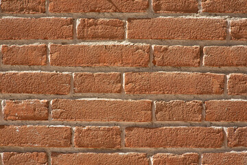 Obraz premium New exposed brick wall without plaster with fired clay bricks and cement mortar suitable for outdoor use