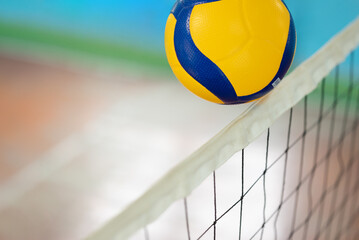Close up of a ball over the net on volleyball court. Concept of playing volleyball, championship, competition