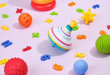 Colorful tactile and sensory balls, spinning top and multicolored numbers on table. Play time.