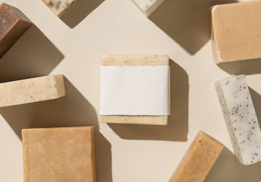 Beige and brown soap bars on light beige close up, hard shadows, packaging mockup