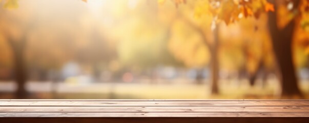 blank wooden table on blurry park background in autumn