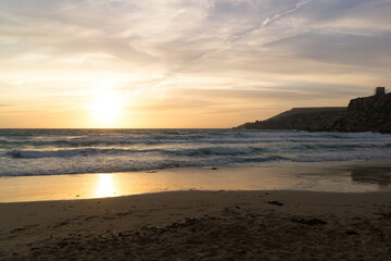 Stunning sunset over sea in Golden Bay Malta.