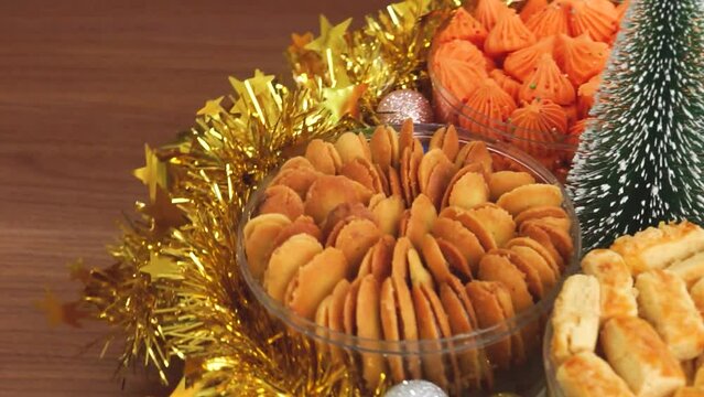 Assortment of Indonesian kue kering including putri salju and kastengel arranged for Christmas celebration parcel