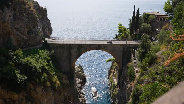Wide scenic view of Fiordo di Furore Bridge and Mediterranean sea(Fjord of Furore) , unusual beautiful hidden place in province of Salerno in Campania region, on sunny summer day, slow motion.