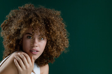 close up portrait of beautiful young woman with curly hair 