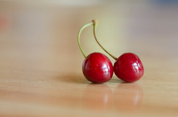 sweet and fresh fruit, red cherries close-up on wooden table and space to fill