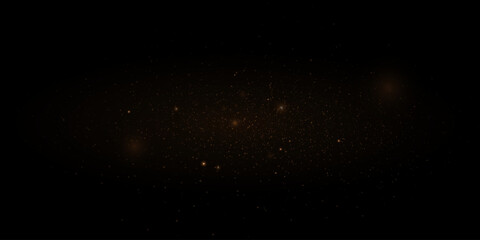 Golden glitter. Flare light effect. Shiny background of particles and light. Gold dust on a black background.