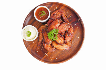 Cooked grilled chicken wings marinated with seasonings Placed on an old wooden tray on a white background