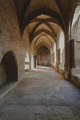 Fototapeta na wymiar Interior corridor in ancient landmark building with gothic arch in a medieval architecture in Narbonne