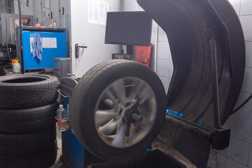 Computer wheel balancing on special equipment machine tool in auto repair service