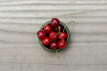 sweet cherries, recently harvested on wood seen from above