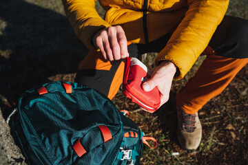 Open a first aid kit with medicines, a hiker on a hike uses a first aid kit, tourist equipment,...