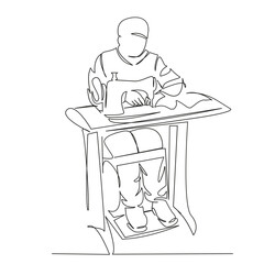 male tailor sews on a sewing machine