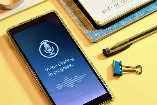 Smartphone screen displaying voice cloning using artificial intelligence in progress. Text to speech synthesis or real time voice cloning approach concept.